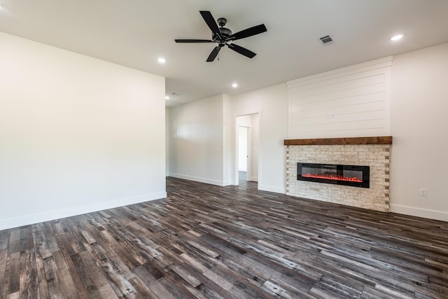 unfurnished living room featuring ceiling fan and dark hardwood / wood-style flooring