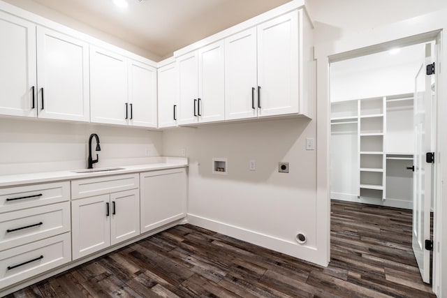 clothes washing area featuring cabinets, sink, hookup for an electric dryer, and dark wood-type flooring