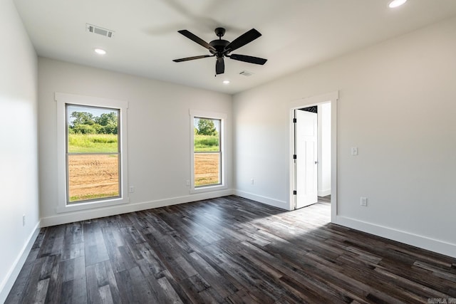 unfurnished room featuring dark hardwood / wood-style floors and ceiling fan