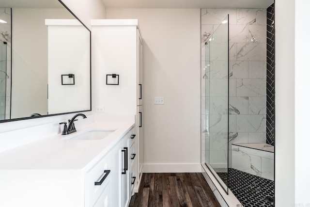 bathroom with vanity, hardwood / wood-style floors, and a tile shower