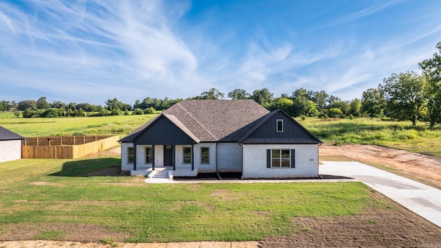 view of front of property with covered porch and a front lawn