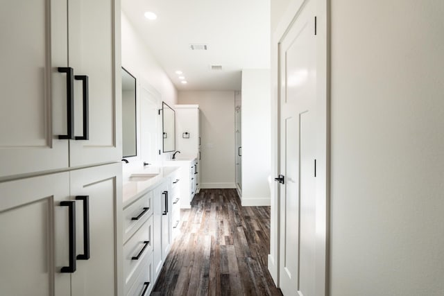 bathroom featuring hardwood / wood-style flooring, vanity, and walk in shower