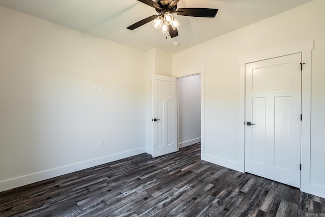 unfurnished bedroom with dark wood-type flooring and ceiling fan