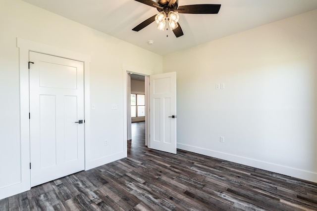 unfurnished bedroom featuring dark hardwood / wood-style flooring and ceiling fan