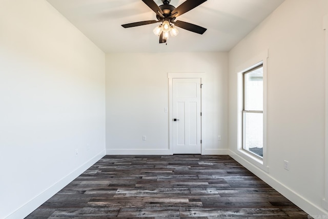 empty room featuring dark hardwood / wood-style floors and ceiling fan