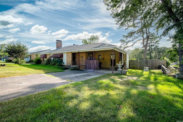 single story home featuring fence, a chimney, and a front yard