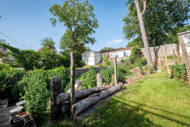 view of yard with a fenced backyard and a garden