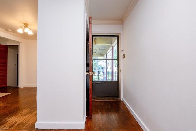 hall with crown molding, baseboards, and wood finished floors