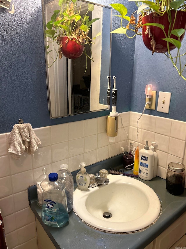 bathroom with sink and backsplash