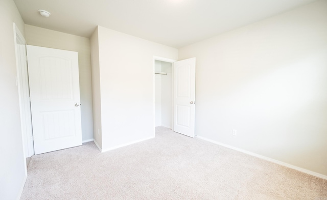 unfurnished bedroom with light colored carpet