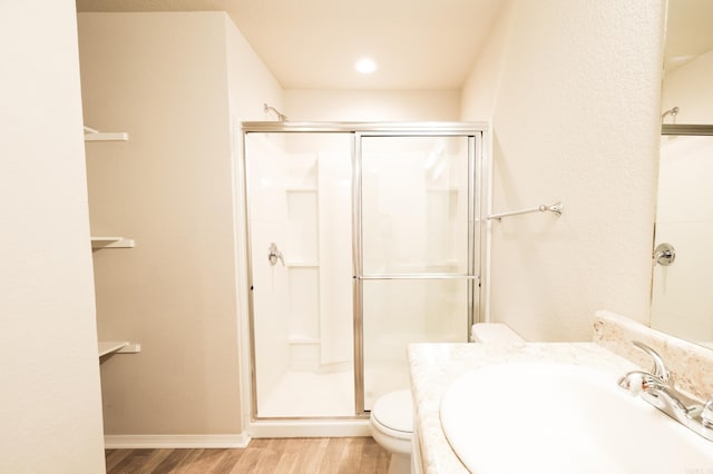 bathroom with sink, toilet, walk in shower, and hardwood / wood-style floors