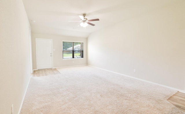 empty room with light carpet, ceiling fan, and lofted ceiling