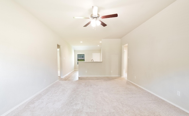 carpeted spare room with ceiling fan