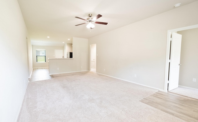 spare room with light carpet and ceiling fan