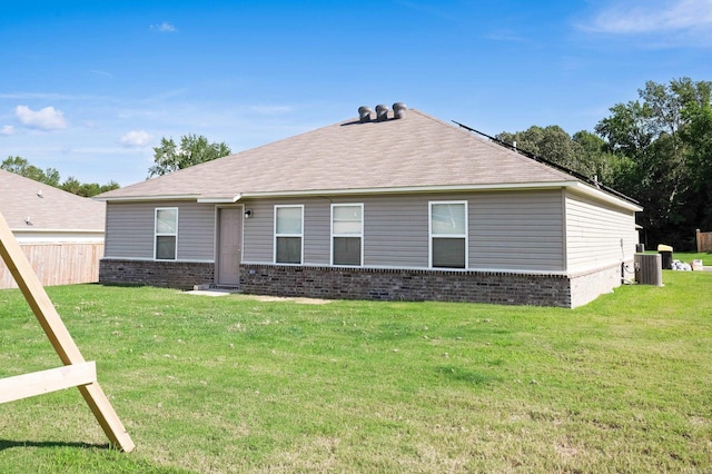 exterior space with central AC and a lawn