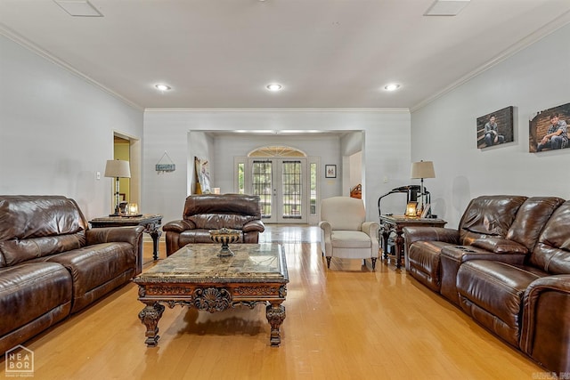 living room with ornamental molding, light hardwood / wood-style flooring, and french doors