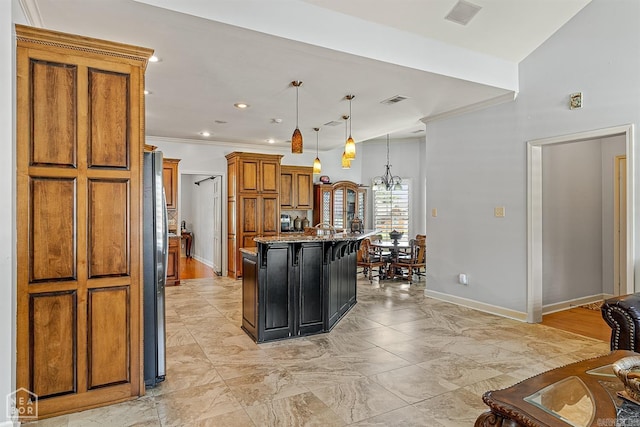 kitchen with a kitchen island with sink, light stone countertops, hanging light fixtures, and light hardwood / wood-style floors