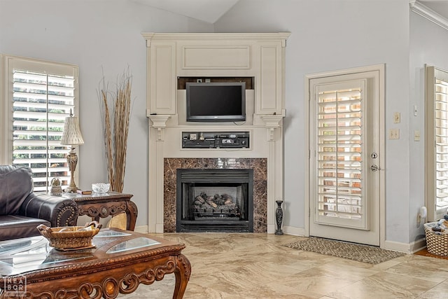 living room with light tile patterned flooring, a premium fireplace, and high vaulted ceiling