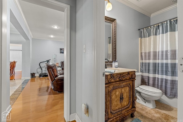 bathroom with hardwood / wood-style flooring, toilet, vanity, and ornamental molding