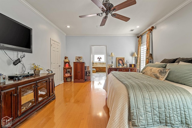 bedroom featuring ornamental molding, ceiling fan, and light wood-type flooring