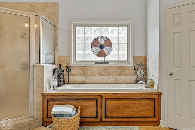 bathroom featuring separate shower and tub