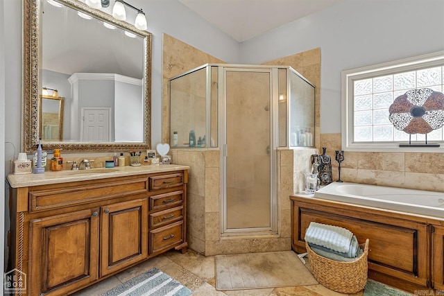 bathroom with vanity, plus walk in shower, tile patterned flooring, and tile walls