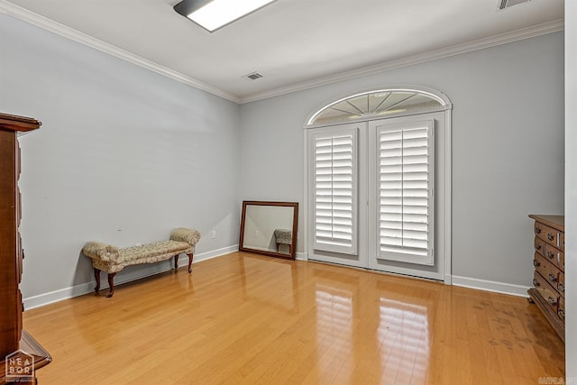 unfurnished room with light hardwood / wood-style floors and crown molding