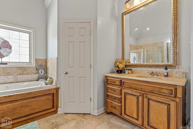 bathroom featuring tile patterned flooring, shower with separate bathtub, and vanity