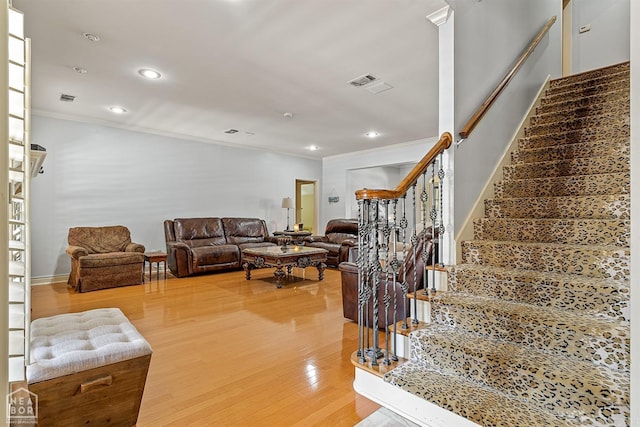 living room featuring hardwood / wood-style floors and ornamental molding