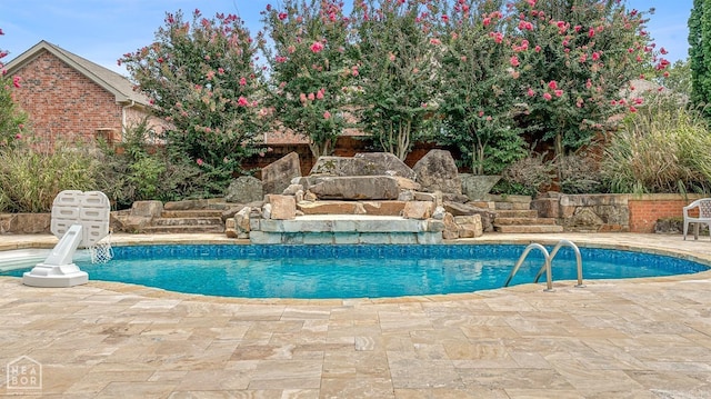 view of pool featuring pool water feature and a patio area