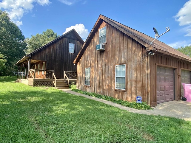 view of home's exterior featuring a garage and a lawn