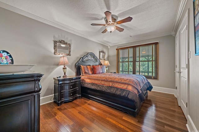 bedroom with dark wood-style floors, a textured ceiling, baseboards, and crown molding