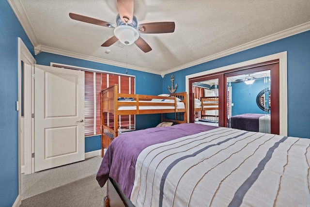 bedroom featuring ceiling fan, a textured ceiling, light colored carpet, baseboards, and crown molding