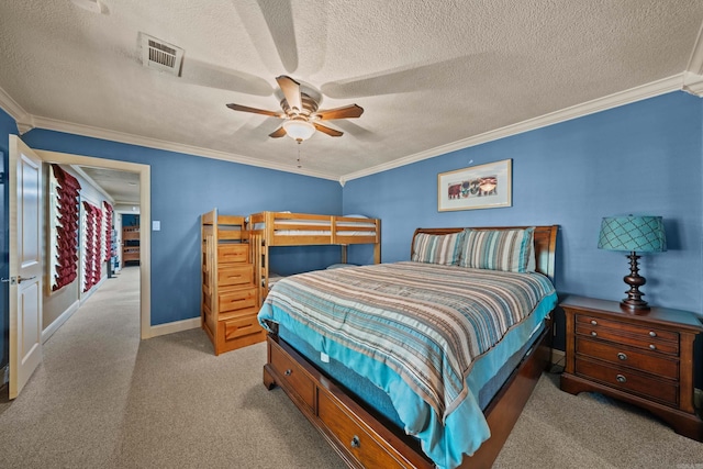 bedroom with visible vents, crown molding, and a textured ceiling