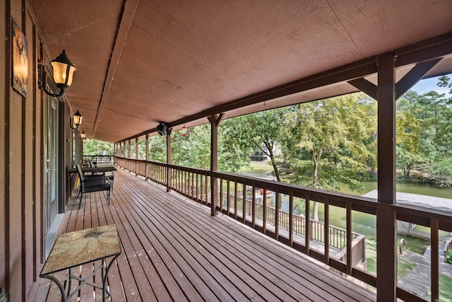 wooden terrace featuring a water view