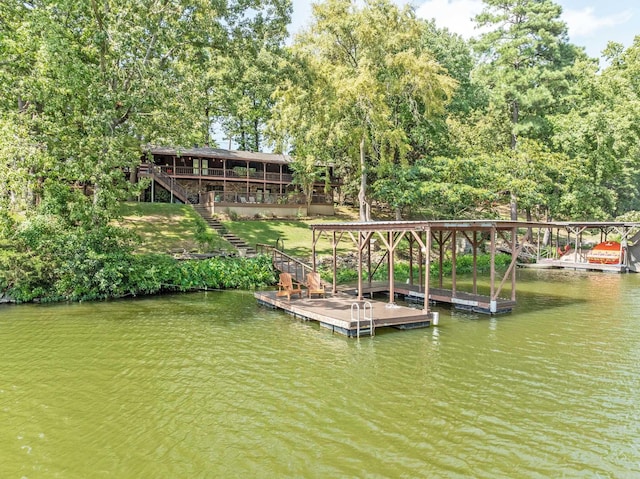 dock area with stairway and a water view