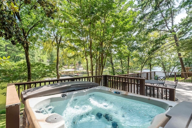 view of swimming pool with a deck and a hot tub