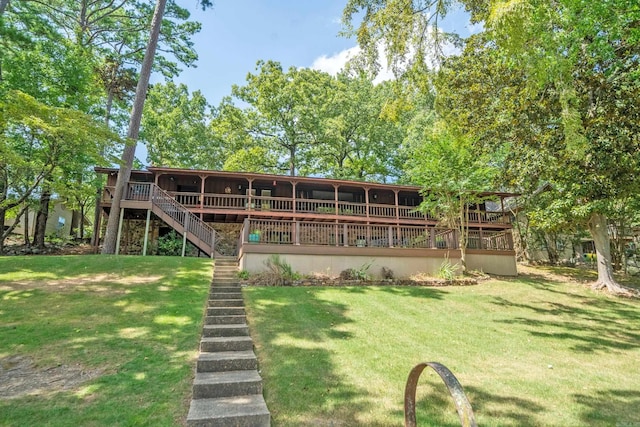 back of house with a deck, a lawn, and stairway