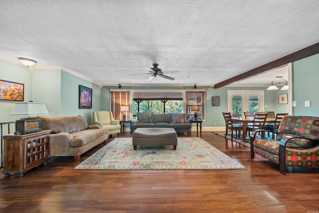 living area featuring a textured ceiling, ornamental molding, dark wood finished floors, and a wealth of natural light