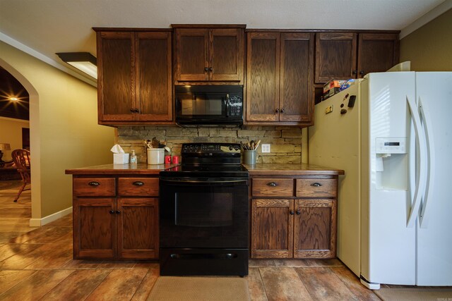 kitchen featuring backsplash, wood-type flooring, black appliances, and ornamental molding