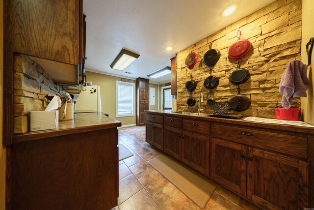 kitchen featuring sink, white fridge, and light tile patterned floors