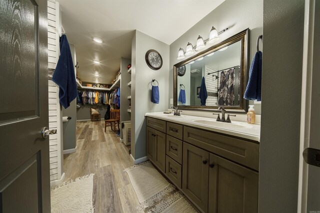 bathroom featuring dual vanity and hardwood / wood-style flooring