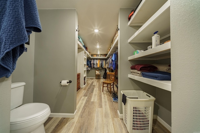 bathroom featuring hardwood / wood-style flooring and toilet