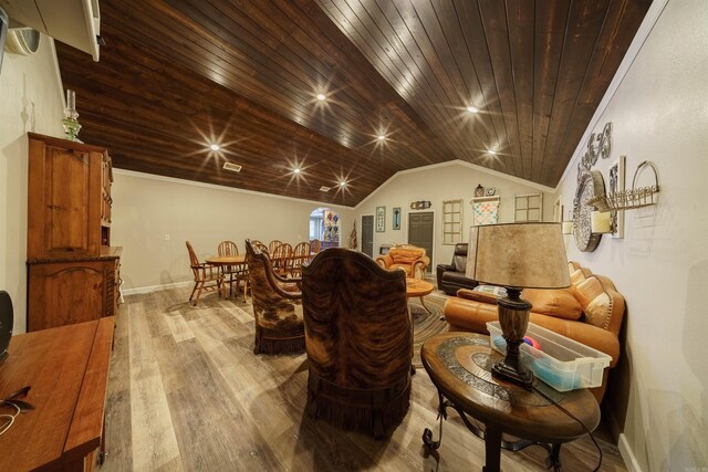 living room with light hardwood / wood-style floors, ornamental molding, wooden ceiling, and lofted ceiling