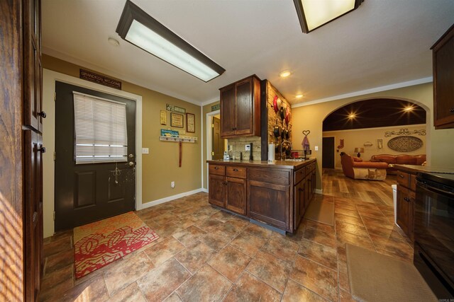 tiled foyer featuring crown molding and sink