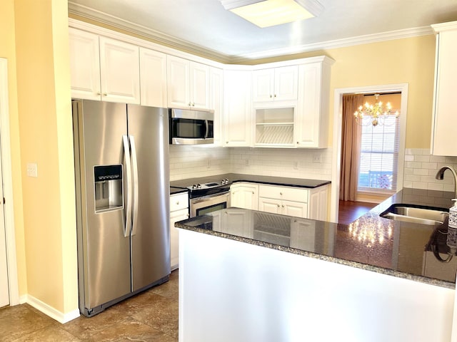 kitchen featuring white cabinetry, sink, dark stone countertops, kitchen peninsula, and stainless steel appliances