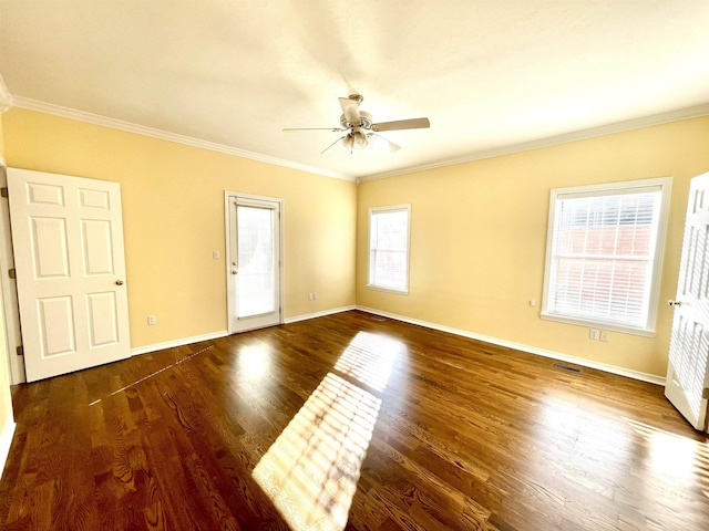 spare room featuring crown molding, dark hardwood / wood-style floors, and ceiling fan