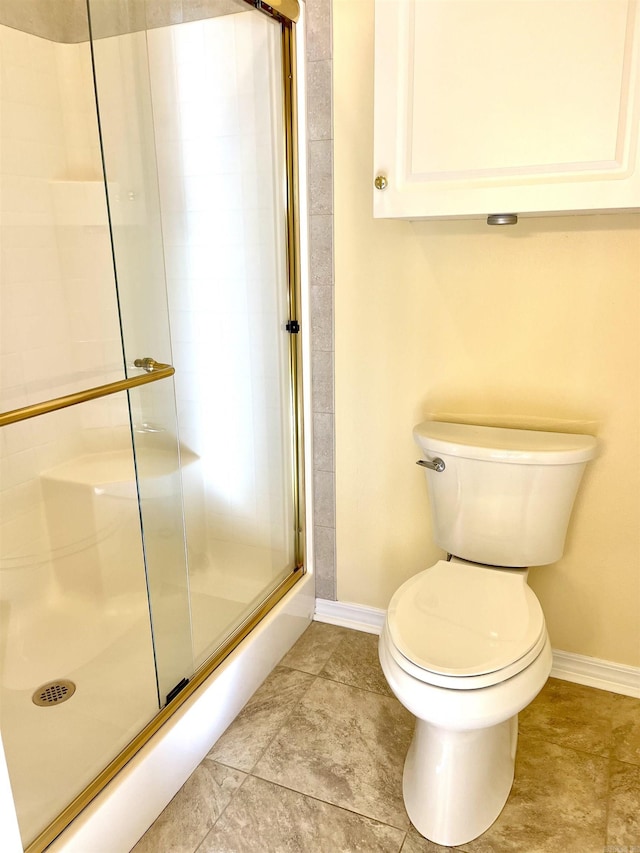 bathroom with toilet and an enclosed shower