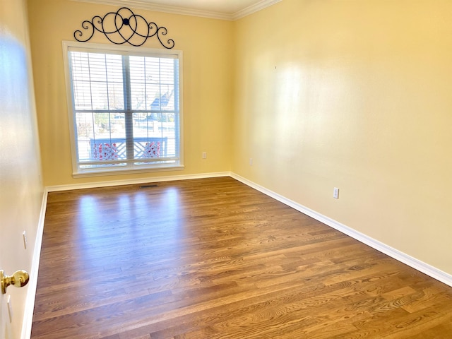 spare room with hardwood / wood-style flooring and ornamental molding