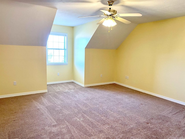 additional living space with vaulted ceiling, ceiling fan, and carpet floors